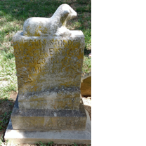 A stone monument with text on it  Description automatically generated